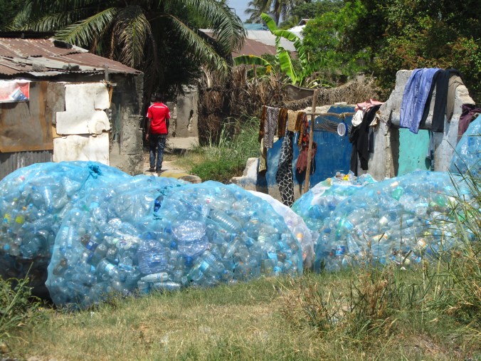 Plastic bottles are collected by men walking the streets hours each day, who sell them to a company for very little money, and the company then sends them to China to be recycled. 